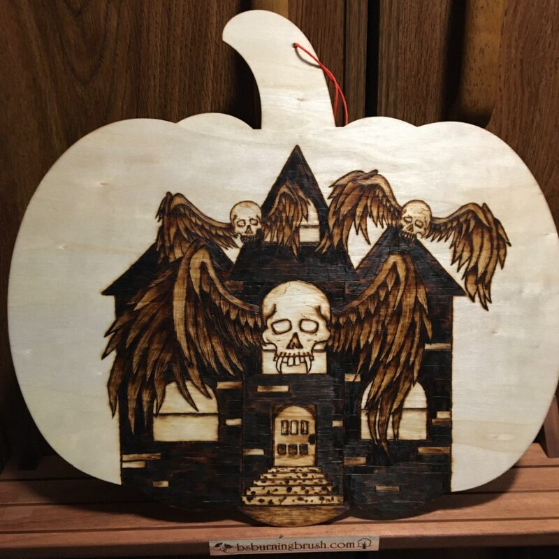 pumpkin-shaped wooden wall decor winged skulls haunted house pyrography wood burning